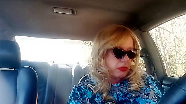 Mature blond GILF smoking lengthy cigarettes while driving her car