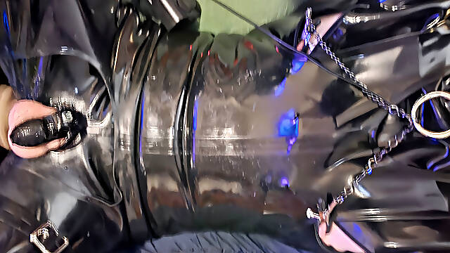 Rubber slave in chastity being fucked by fucking machine